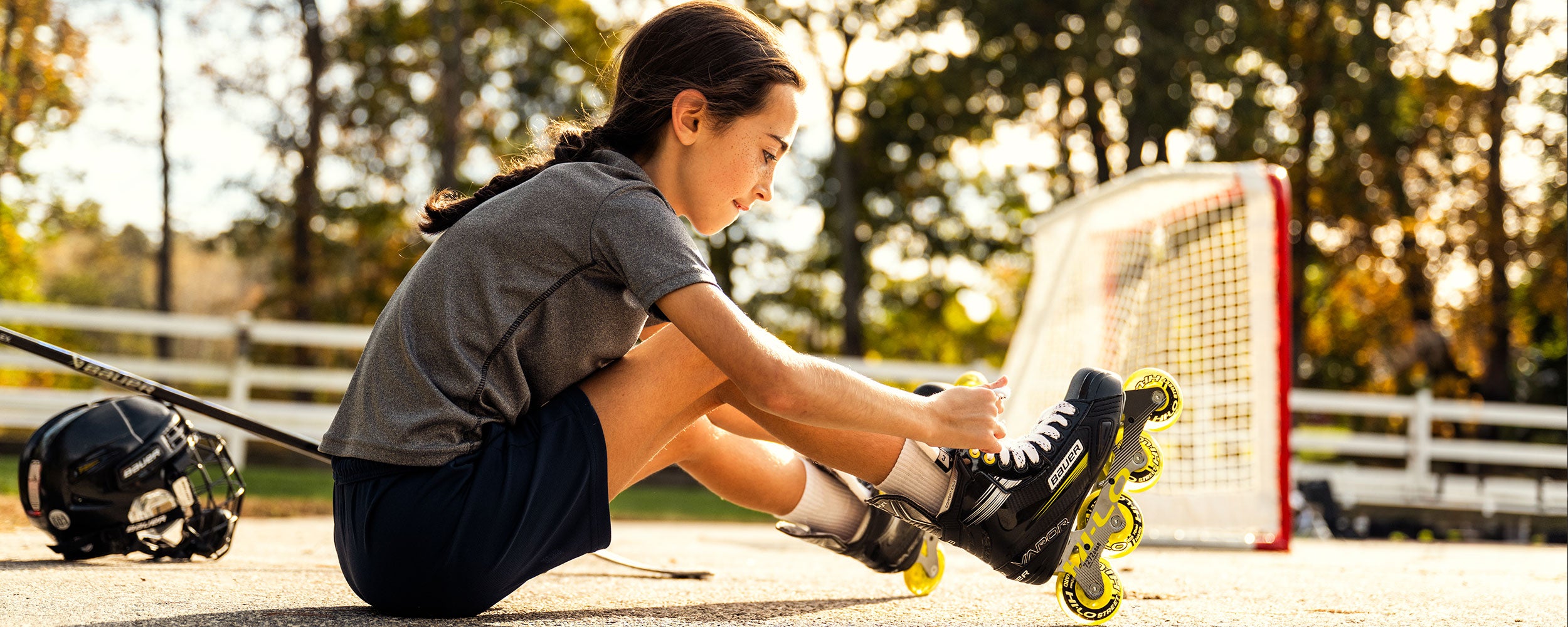 Girl tying up her X3 inline skates
